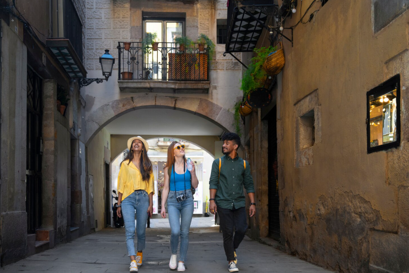 Friends walking through a historic city street while exploring local landmarks and architecture.