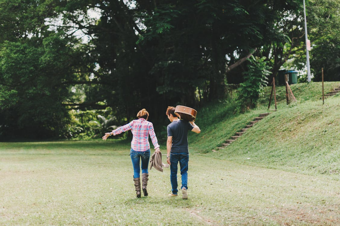 Couple enjoying a free outdoor walk and music as part of no-spend weekend ideas for couples.