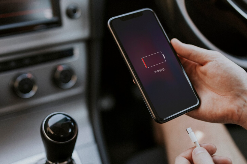 Smartphone showing low battery, illustrating how weather can drain phone battery faster.