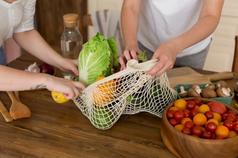 Unpacking groceries with core ingredients for capsule kitchen meal planning.